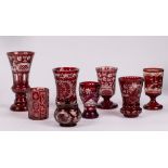 A group of engraved ruby overlay glass comprising an octagonal beaker, three flared vases,