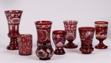 A group of engraved ruby overlay glass comprising an octagonal beaker, three flared vases,