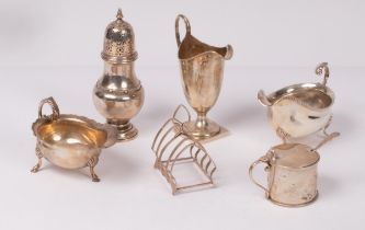 A group of table silver comprising cream jug, Nathan & Hayes, Chester 1908, a sugar caster,