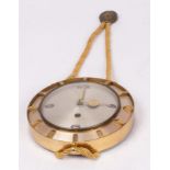 A 1960s clockwork wall clock in a brass case with rope border,