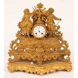 A 19th Century gilt metal eight-day mantel clock with figural surmount,