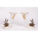 A pair of white glass frill-rimmed cornucopia with gilt metal stag-head terminals,
