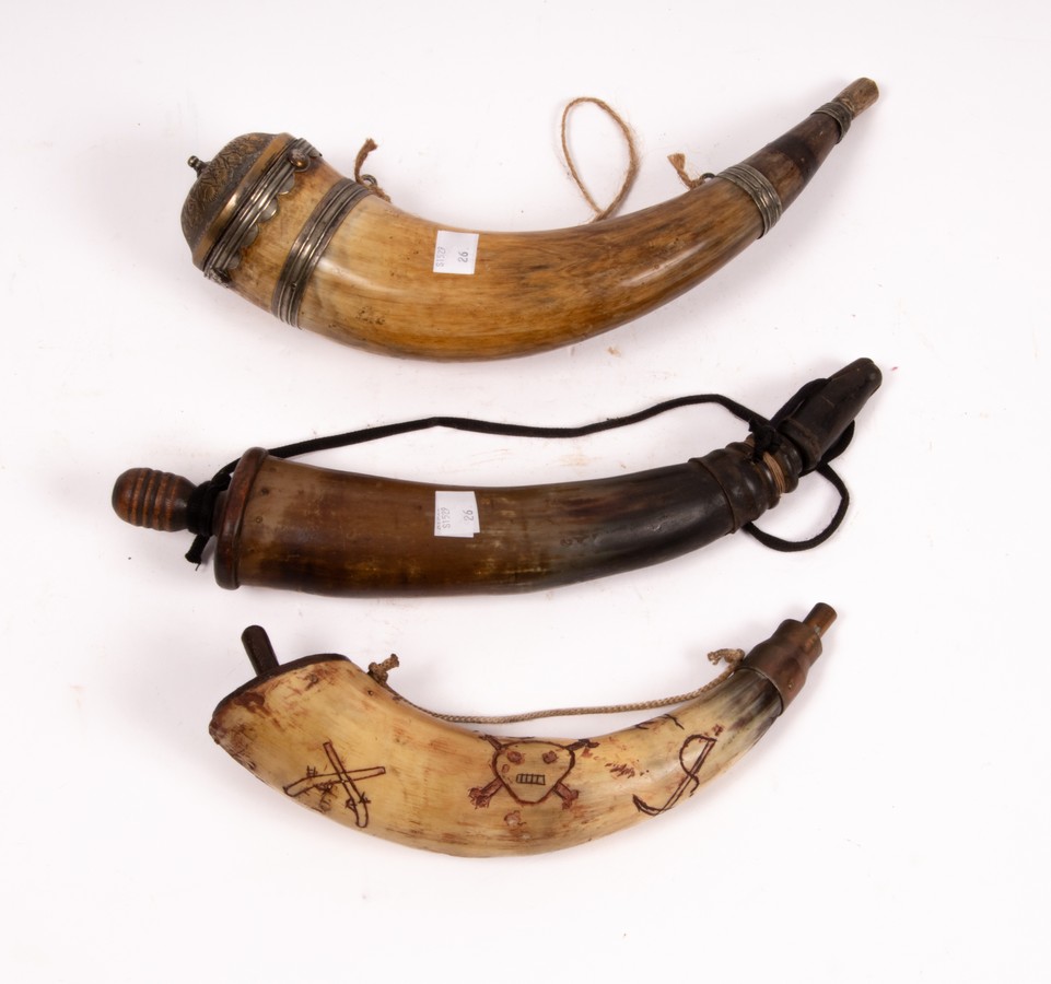 An Eastern powder horn with metal mounts and engraved brass cover, 22cm long,