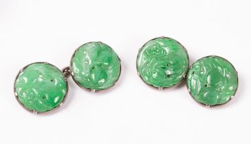 A pair of carved jade cufflinks, the circular links set in white metal, boxed by WAT de Silva,