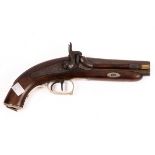 A double-barrel percussion cap pistol with engraved metal mounts and cap end,