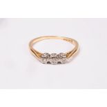 A diamond three-stone ring, illusion set in 18ct gold, approximately 2g,