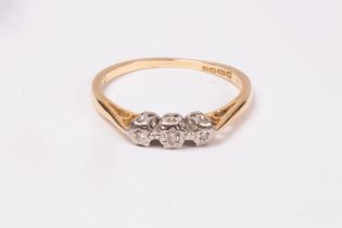 A diamond three-stone ring, illusion set in 18ct gold, approximately 2g,