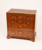 A George III walnut chest, the top crossbanded and fitted four drawers with brushing slide,