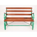 A slatted garden seat with wrought iron green painted scroll ends,