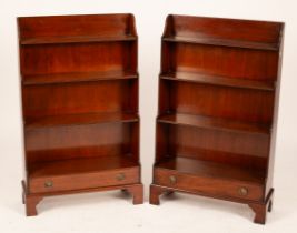 A pair of mahogany waterfall front open bookcases, each fitted a drawer and on bracket feet, 64.