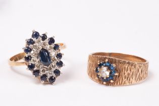 A diamond and sapphire cluster ring, lozenge shaped and set in 18ct yellow gold,