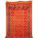 A Bessarabian kilim, Eastern Europe, the abrashed strawberry field of serrated vines issuing leaves,