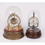 A Eureka brass pillar mantel clock with electric oscillating movement, under a glass dome,
