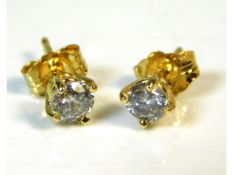 A pair of 18ct gold earrings set with approx. 0.4c