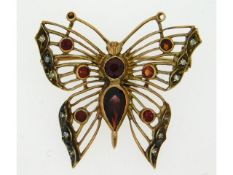 A 9ct butterfly brooch set with diamonds & garnets, lacking a garnet stone in one antenna, 30mm x 30