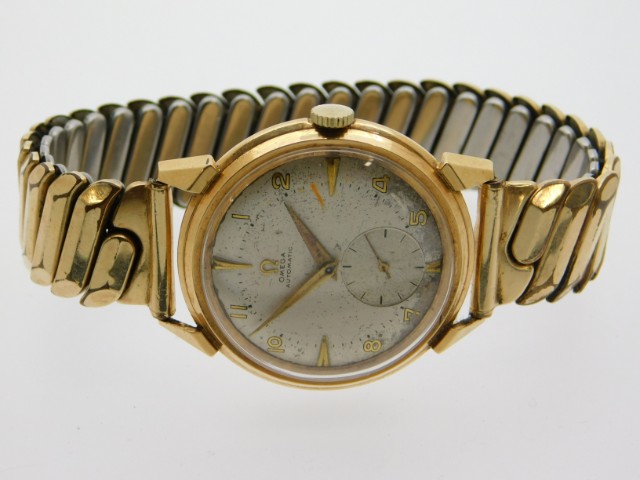 A gents vintage Omega wrist watch with plated stra