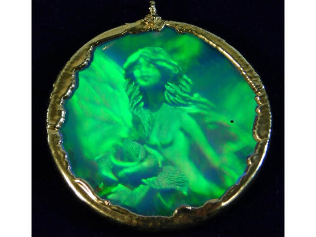 An iridescent crystal hologram of nymph mounted in