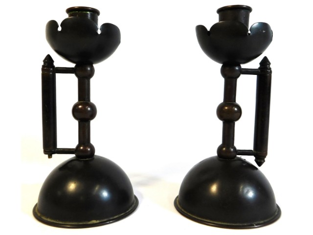 A pair of c.1886 bronze arts & crafts Christopher Dresser designed candle holders, loss to one lower