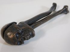 A c.1932 set of bronze skull & cross bone nut crac