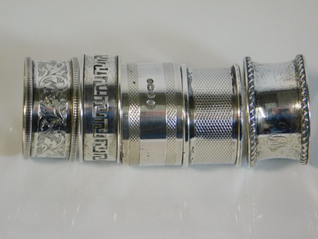 Five silver napkin rings including a heavy gauge ring by Francis Howard Ltd. 53.7g, total weight 125