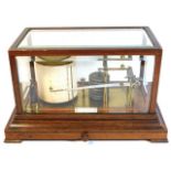 A Negretti & Zamba barograph set within an oak & b