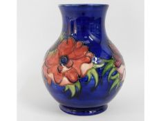 A Moorcroft pottery vase with green signature to b