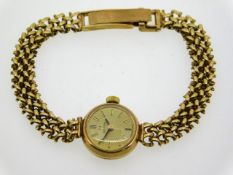 A ladies 9ct gold Omega wrist watch, case diameter 17mm, 6.5in long, 15g, currently running