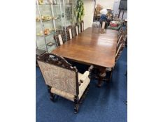 A large 19thC. extending oak dining table with nin