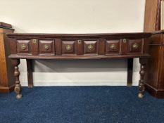 A 17thC. oak dresser base with later rear legs, 72