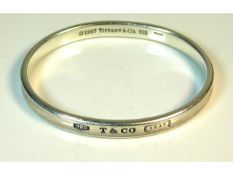 A 1997 Tiffany & Co. silver bangle with original box, 62mm internal diameter, 31.5g, inscribed "Love