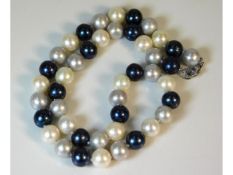A set of three colour cultured pearls with silver clasp, 55.5g, 17.5in long