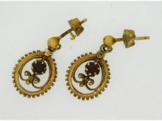 A pair of 9ct gold drop earrings set with floral d