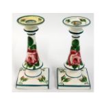 A pair of Wemyss cabbage rose candle holders retailed by T. Goode & Co. one with restoration, 7in ta