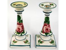 A pair of Wemyss cabbage rose candle holders retailed by T. Goode & Co. one with restoration, 7in ta