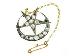 An antique white metal star & moon brooch set, tests electronically as 14ct gold, set with approx. 1