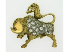 A yellow metal Taurus bull pendant set with white