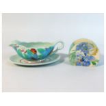 A Clarice Cliff gravy boat & stand twinned with an