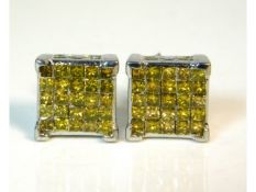 A pair of silver earrings set with 1.5ct of yellow