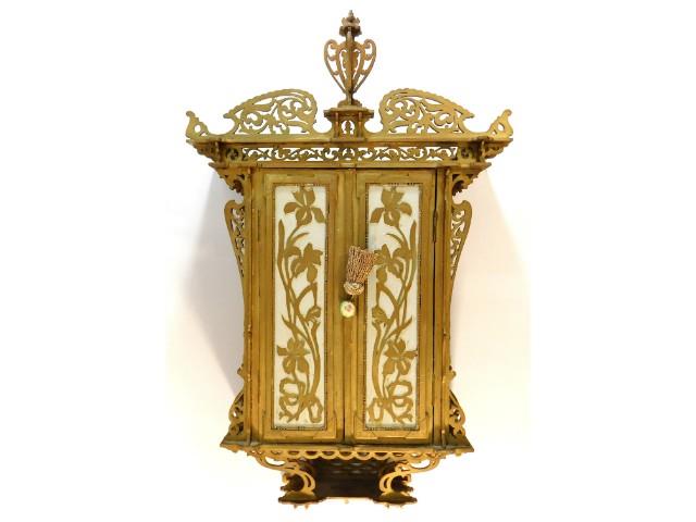 A 1920's gilded cabinet with fretwork decor, loss