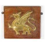 A mounted brass plaque depicting a dragon, removed from the wardroom of the 1917 built HMS Dragon, a