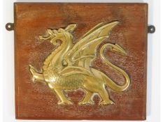 A mounted brass plaque depicting a dragon, removed from the wardroom of the 1917 built HMS Dragon, a