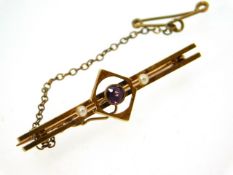 An antique 15ct gold bar brooch set with amethyst