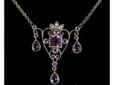 An Edwardian 9ct gold necklace set with pink tourm