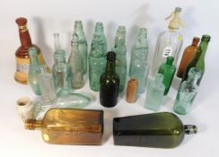 A collection of mostly antique glass bottles including De Kuyper liqueur, Heatherdale Scotch Whisky,