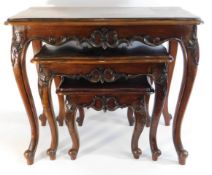 A decorative nest of mahogany tables, largest 26.5