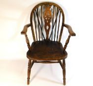 An antique elm wheel back armchair, 37in high to b