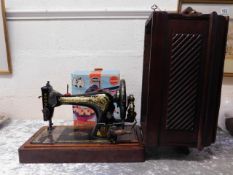 A Singer sewing machine with case twinned with an