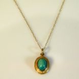 A yellow metal chain with yellow metal & turquoise