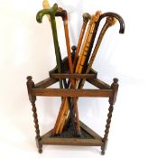 A barley twist oak stick stand with eight sticks i