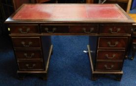 A three piece pedestal desk with red leather style